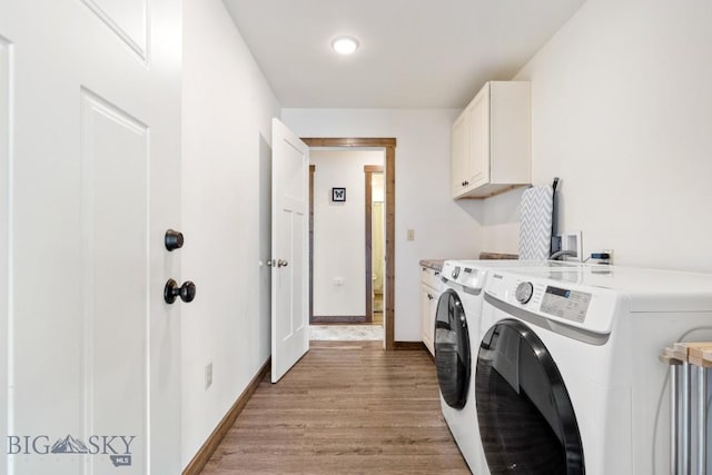 83 Sky Vw, Ennis, MT 59729 - laundry room with cabinet space, washer and clothes dryer, light wood finished floors, and baseboards