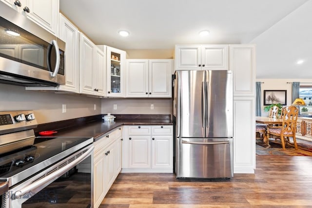 83 Sky Vw, Ennis, MT 59729 - kitchen with appliances with stainless steel finishes, wood finished floors, dark countertops, white cabinetry, and recessed lighting