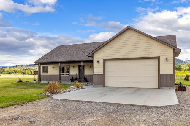 83 Sky Vw, Ennis, MT 59729 - view of front of house with driveway, a mountain view, a porch, a front yard, and roof with shingles