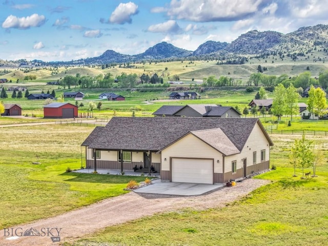 83 Sky Vw, Ennis, MT 59729 - view of front of home with an attached garage, dirt driveway, covered porch, and a mountain view