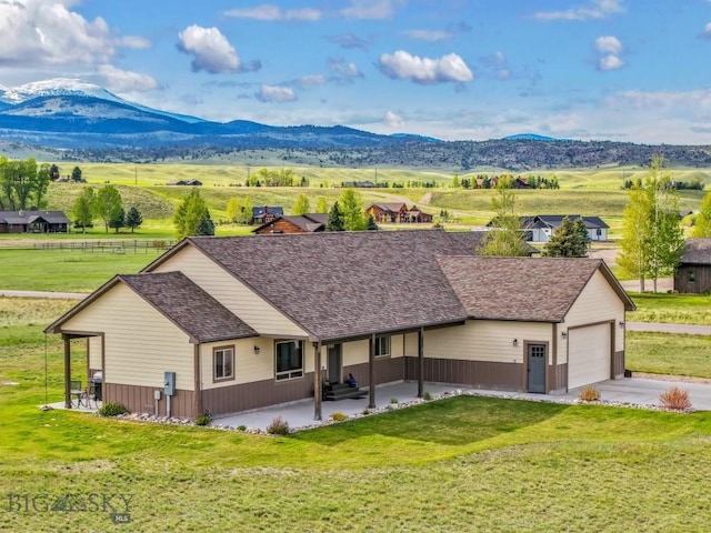 83 Sky Vw, Ennis, MT 59729 - view of front of property featuring concrete driveway, a front yard, a mountain view, and an attached garage