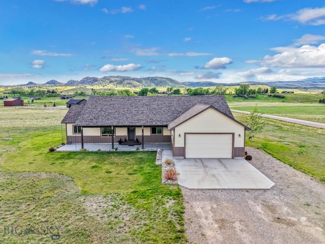 83 Sky Vw, Ennis, MT 59729 - ranch-style house featuring covered porch, driveway, a mountain view, and a garage
