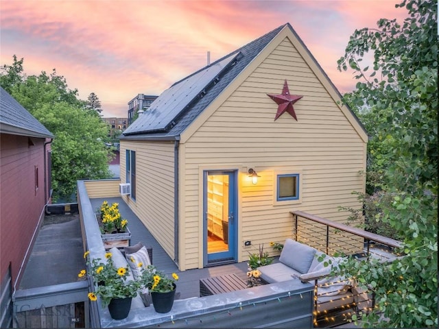 309 N Black Ave, Bozeman, MT 59715 - back of house at dusk with an outdoor living space and cooling unit