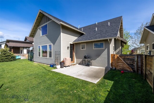 4156 Sunstone St, Bozeman, MT 59718 - rear view of property featuring a gate, a patio, a fenced backyard, a lawn, and a shingled roof