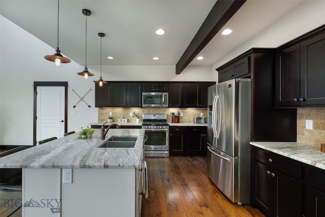 4156 Sunstone St, Bozeman, MT 59718 - kitchen with dark wood-type flooring, a sink, an island with sink, light stone counters, and appliances with stainless steel finishes