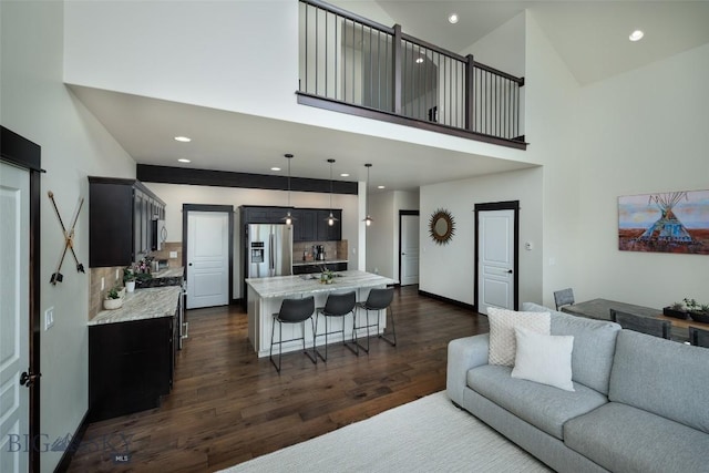 4156 Sunstone St, Bozeman, MT 59718 - living area with dark wood finished floors, baseboards, high vaulted ceiling, and recessed lighting