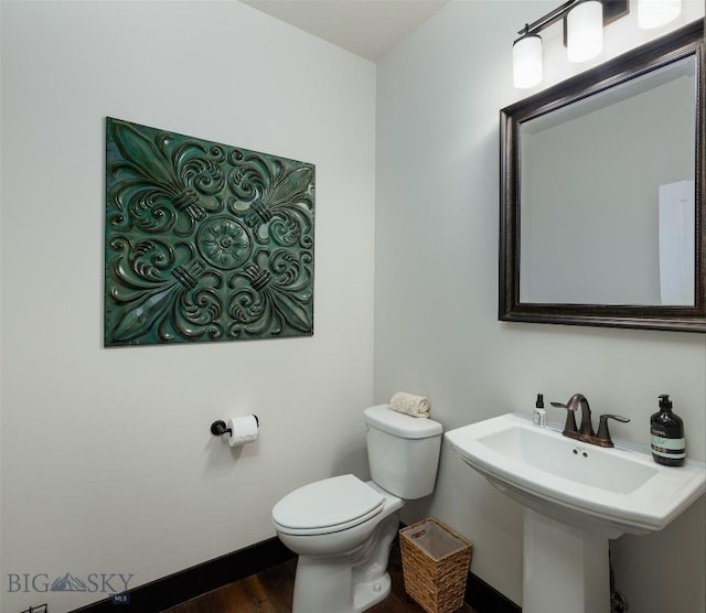 4156 Sunstone St, Bozeman, MT 59718 - bathroom featuring wood finished floors, toilet, and a sink