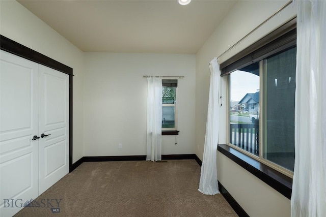 4156 Sunstone St, Bozeman, MT 59718 - unfurnished bedroom featuring baseboards, a closet, and dark carpet