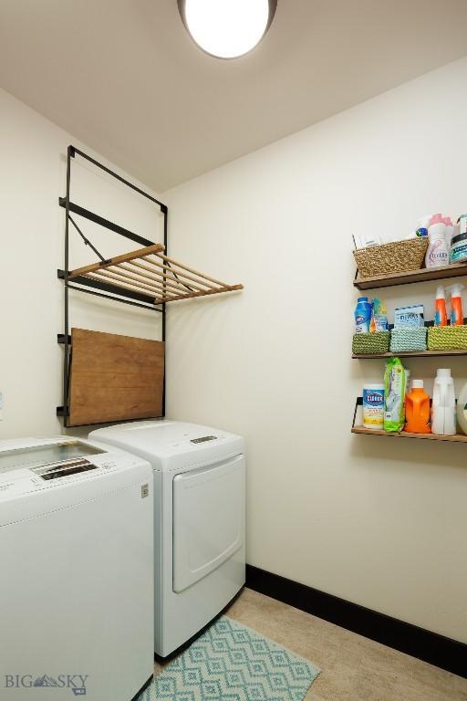 4156 Sunstone St, Bozeman, MT 59718 - clothes washing area with laundry area, baseboards, and separate washer and dryer