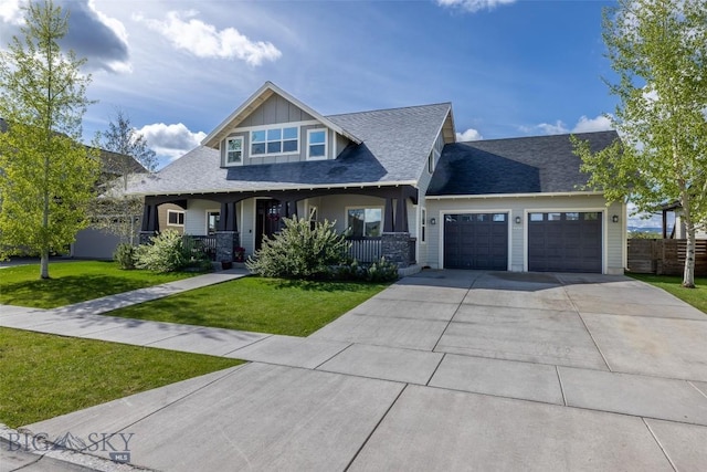 4156 Sunstone St, Bozeman, MT 59718 - craftsman inspired home featuring driveway, a front yard, roof with shingles, an attached garage, and a porch