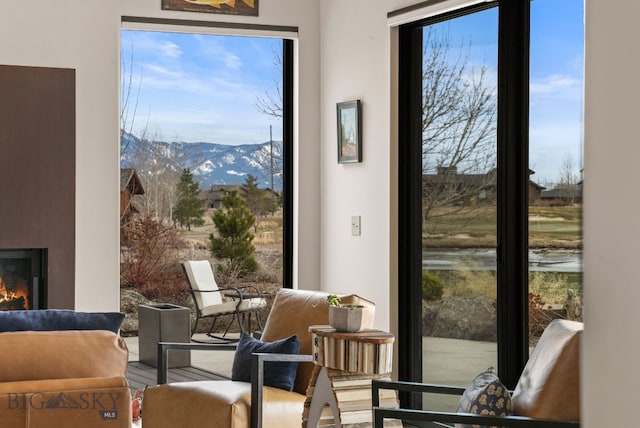 676 Tillyfour, Bozeman, MT 59718 - doorway with a mountain view and a warm lit fireplace
