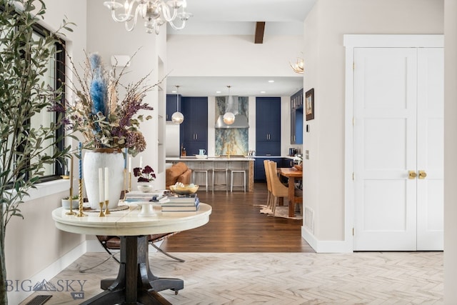676 Tillyfour, Bozeman, MT 59718 - entrance foyer with a chandelier, beam ceiling, and wood finished floors