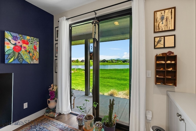 676 Tillyfour, Bozeman, MT 59718 - doorway to outside featuring a water view and wood finished floors
