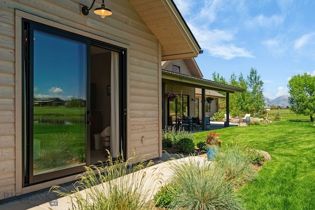 676 Tillyfour, Bozeman, MT 59718 - entrance to property with a patio, a lawn, and a water and mountain view