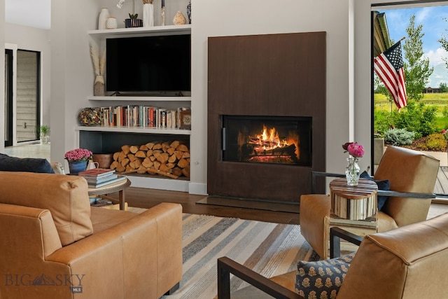 676 Tillyfour, Bozeman, MT 59718 - living room featuring wood finished floors and a lit fireplace