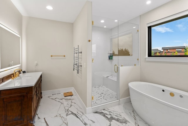 676 Tillyfour, Bozeman, MT 59718 - bathroom featuring vanity, marble finish flooring, a freestanding bath, recessed lighting, and a stall shower