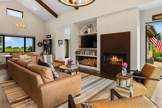 676 Tillyfour, Bozeman, MT 59718 - living room featuring a chandelier, hardwood / wood-style floors, a fireplace with flush hearth, high vaulted ceiling, and beamed ceiling