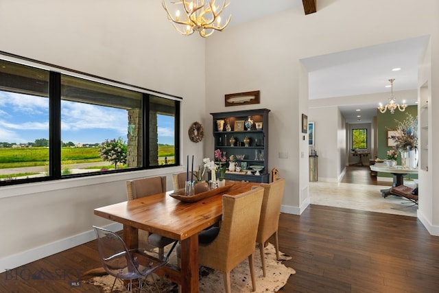 676 Tillyfour, Bozeman, MT 59718 - dining space with a chandelier, dark wood-style flooring, and a high ceiling