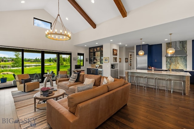 676 Tillyfour, Bozeman, MT 59718 - living area featuring dark wood-style floors, high vaulted ceiling, a bar, recessed lighting, and a chandelier
