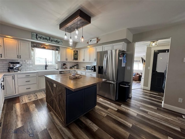 23 Indian Rings Rd, Big Timber, MT 59011 - kitchen featuring stainless steel appliances, wood counters, backsplash, dark wood finished floors, and plenty of natural light