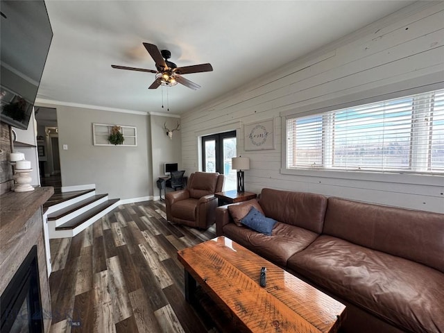 23 Indian Rings Rd, Big Timber, MT 59011 - living area featuring dark wood-type flooring, wood walls, a ceiling fan, and crown molding