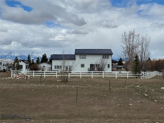 23 Indian Rings Rd, Big Timber, MT 59011 - rear view of house featuring a metal roof and a mountain view