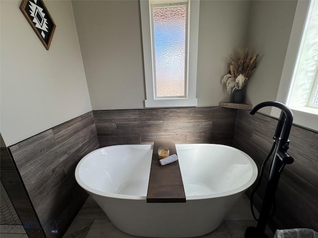 23 Indian Rings Rd, Big Timber, MT 59011 - bathroom with tile walls, a soaking tub, and wainscoting