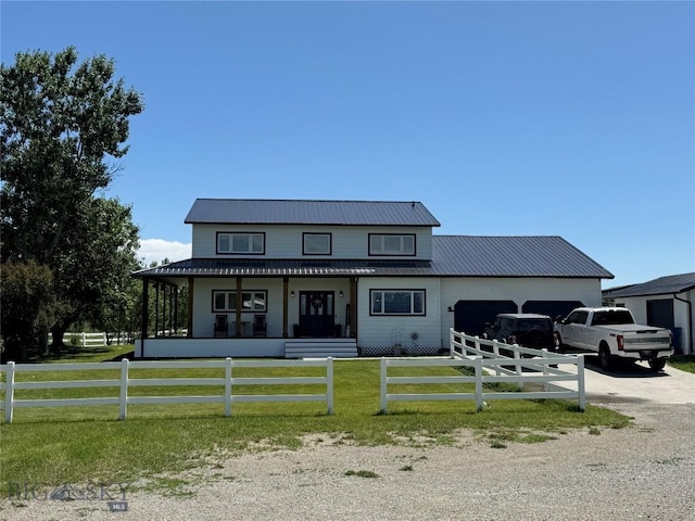 23 Indian Rings Rd, Big Timber, MT 59011 - view of front of home with a garage, concrete driveway, a fenced front yard, and a metal roof