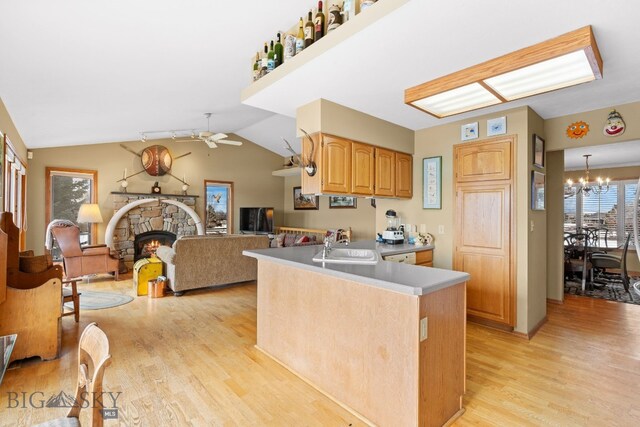 3310 Tumbleweed Dr, Bozeman, MT 59715 - kitchen with a stone fireplace, a sink, light countertops, ceiling fan with notable chandelier, and light wood finished floors