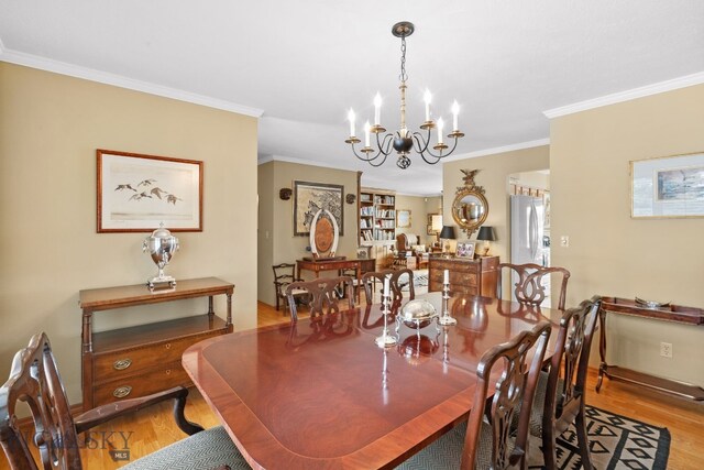 3310 Tumbleweed Dr, Bozeman, MT 59715 - dining space with ornamental molding, wood finished floors, and a chandelier