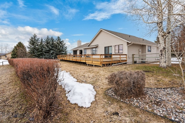 3310 Tumbleweed Dr, Bozeman, MT 59715 - back of house featuring a deck, fence, and a chimney