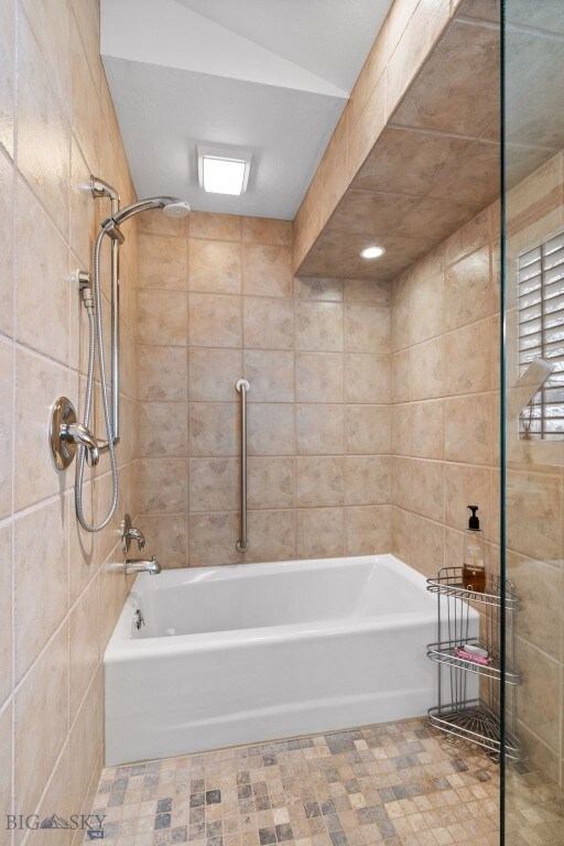 3310 Tumbleweed Dr, Bozeman, MT 59715 - full bath featuring tile patterned floors, tile walls, and shower / washtub combination
