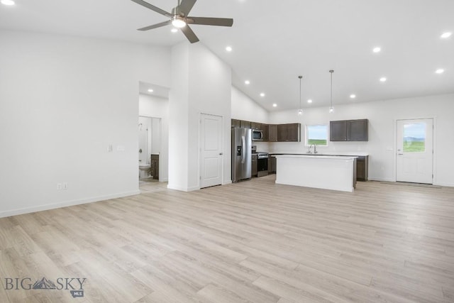 6 S Durango Trl, Three Forks, MT 59752 - kitchen featuring stainless steel appliances, open floor plan, a kitchen island, ceiling fan, and high vaulted ceiling