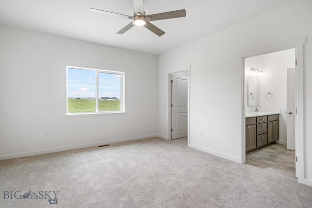 6 S Durango Trl, Three Forks, MT 59752 - unfurnished bedroom with light colored carpet, ensuite bathroom, and a ceiling fan