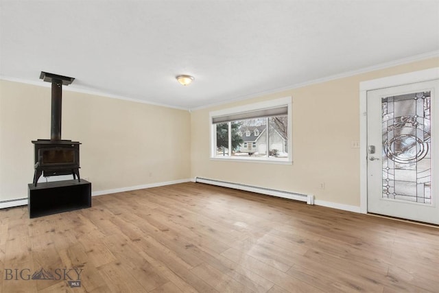 510 Flathead Ave, Bozeman, MT 59715 - unfurnished living room with a baseboard heating unit, crown molding, hardwood / wood-style floors, and baseboards