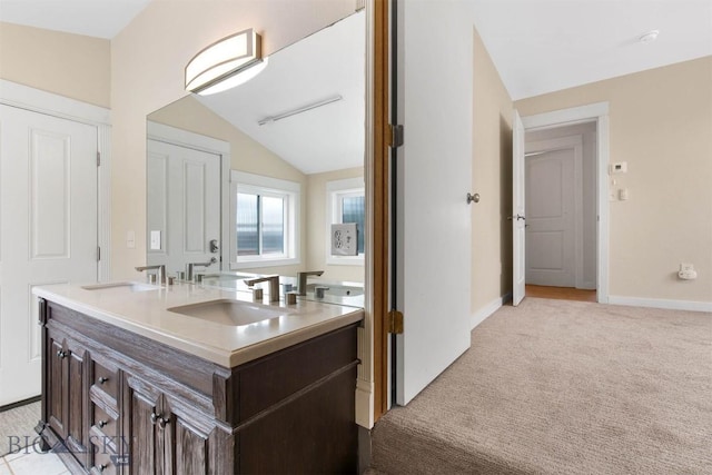 510 Flathead Ave, Bozeman, MT 59715 - full bath featuring double vanity, vaulted ceiling, and baseboards