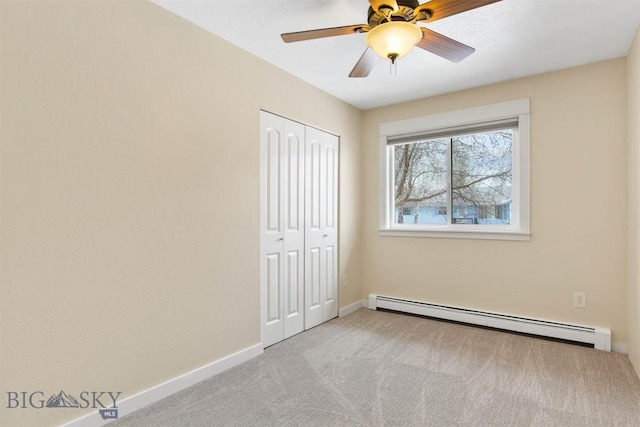 510 Flathead Ave, Bozeman, MT 59715 - unfurnished bedroom with baseboard heating, carpet floors, a closet, baseboards, and ceiling fan