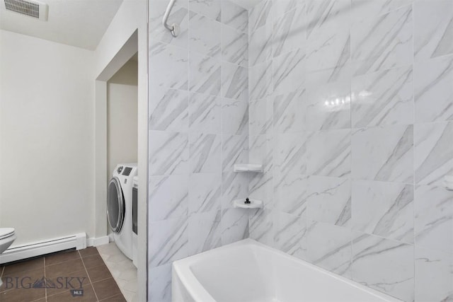 510 Flathead Ave, Bozeman, MT 59715 - full bathroom featuring baseboard heating, toilet, independent washer and dryer, shower / tub combination, and tile patterned floors