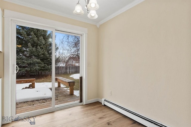 510 Flathead Ave, Bozeman, MT 59715 - doorway to outside with a baseboard radiator, crown molding, a chandelier, light wood-style flooring, and baseboards