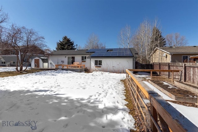 510 Flathead Ave, Bozeman, MT 59715 - snow covered rear of property featuring a garden, roof mounted solar panels, and a deck