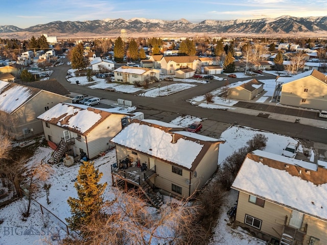 907 Montana St, Belgrade, MT 59714 - snowy aerial view featuring a mountain view and a residential view