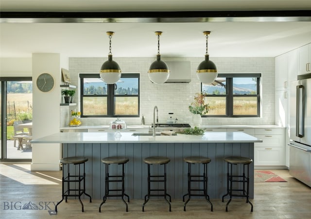 7980 Balsam, Bozeman, MT 59718 - kitchen featuring high end refrigerator, light wood-style flooring, and white cabinetry