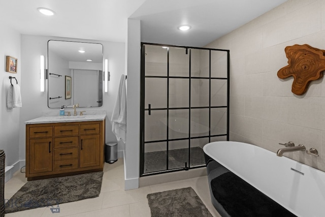 7980 Balsam, Bozeman, MT 59718 - bathroom with vanity, a shower stall, a freestanding tub, tile patterned flooring, and tile walls