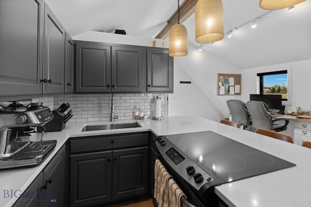 7980 Balsam, Bozeman, MT 59718 - kitchen featuring electric range, decorative backsplash, vaulted ceiling, light countertops, and track lighting