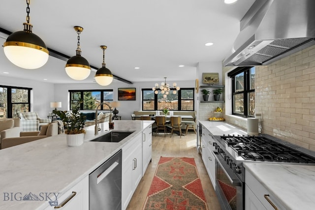 7980 Balsam, Bozeman, MT 59718 - kitchen featuring wall chimney exhaust hood, stainless steel appliances, light wood-style flooring, white cabinets, and recessed lighting