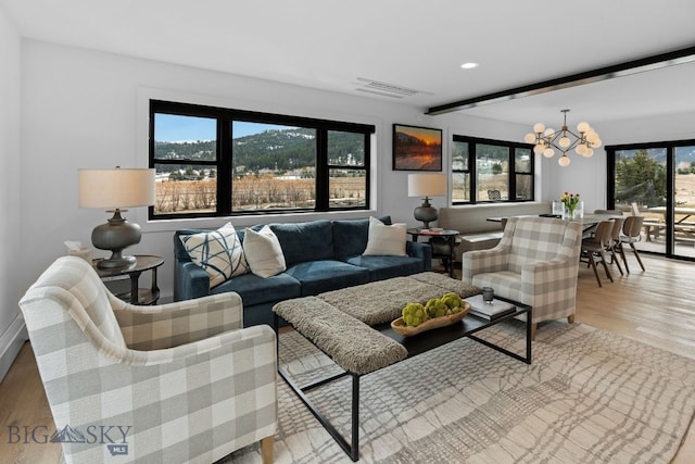 7980 Balsam, Bozeman, MT 59718 - living room featuring a chandelier, wood finished floors, beamed ceiling, and recessed lighting
