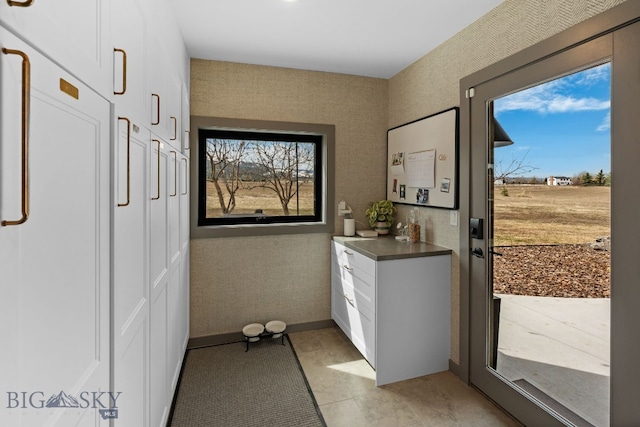 7980 Balsam, Bozeman, MT 59718 - doorway to outside with plenty of natural light and light tile patterned floors