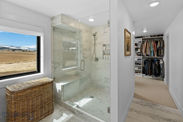 7980 Balsam, Bozeman, MT 59718 - full bathroom featuring a shower stall, a walk in closet, recessed lighting, and marble finish flooring