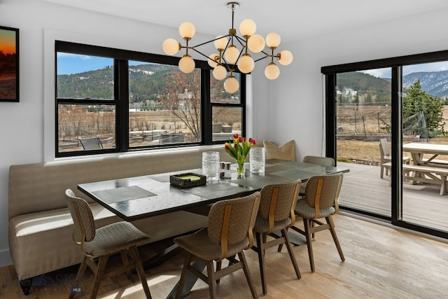 7980 Balsam, Bozeman, MT 59718 - dining room with light wood-style floors, a chandelier, and a mountain view
