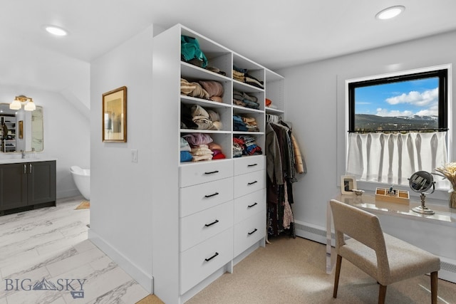 7980 Balsam, Bozeman, MT 59718 - spacious closet with light marble finish flooring and a baseboard heating unit